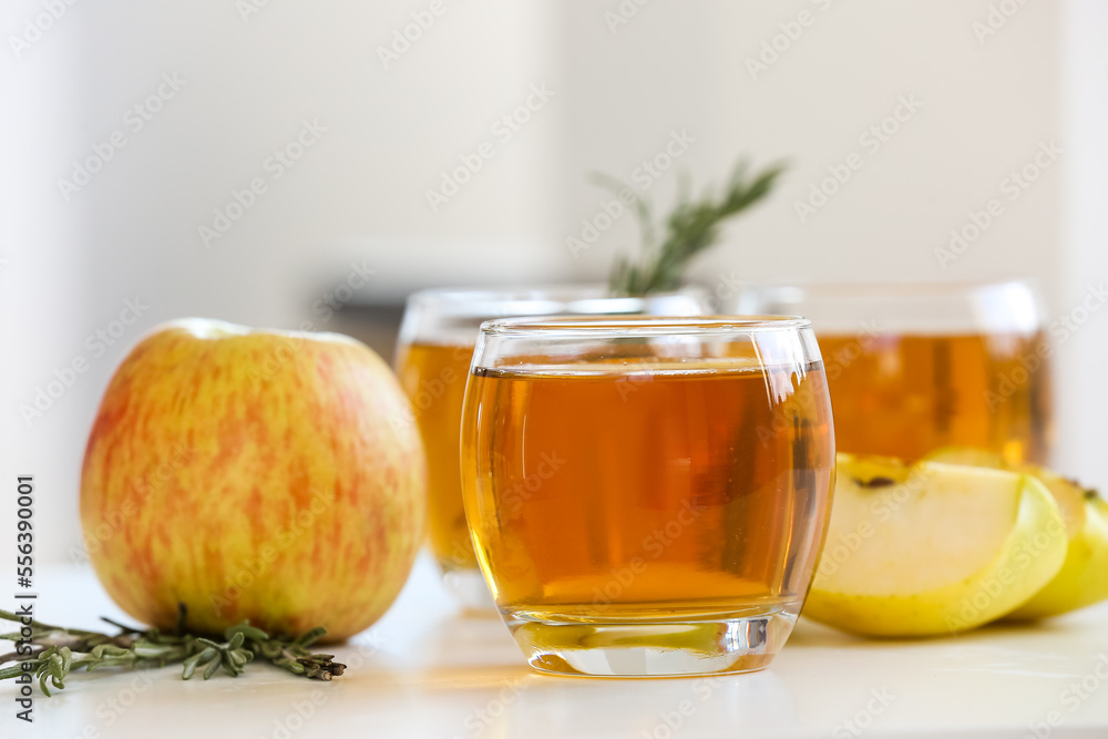 Glasses of fresh apple juice on table, closeup