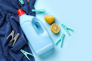 Wall Mural - Laundry detergent, lemon and clothespins on blue background