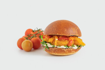 Vegetarian sandwich made from fresh buns, raw vegetables, mashed sweet potato, tahini sauce on white background.