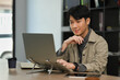© Prathankarnpap - Handsome asian male freelancer working on design project online on laptop computer