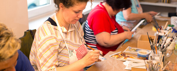 Wall Mural - Women in art workshop making decoupage boxes	