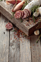 Wall Mural - Dry-cured sausage on a old wooden table.