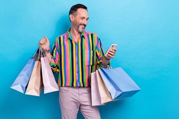 Poster - Photo of extravagant man shopper shopaholih buyer use modern device write positive feedback isolated on blue color background