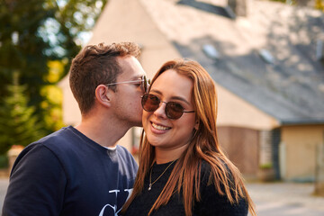 A shallow focus portrait of a lovely young Hispanic couple standing