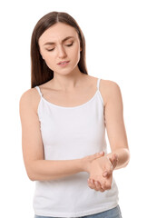 Sticker - Young woman suffering from pain in her hand on white background. Arthritis symptoms