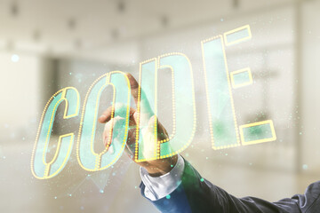 Wall Mural - man hand presses on code word hologram on blurred office background, international software developm