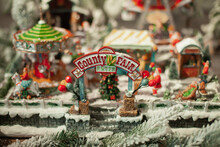 Vintage County Fair Toy Home Decoration With Lights Bokeh For Winter Holiday Season On Sale At Christmas Market. Festive Xmas Background Wallpaper.