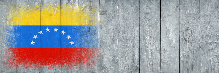 Flag of Venezuela. Flag is painted on a gray wooden plank surface. Wooden background. Plywood surface. Copy space. Textured background