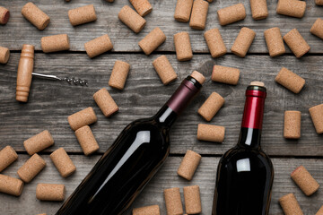 Canvas Print - Wine corks, bottles and corkscrew on wooden table, flat lay