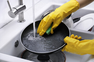 Canvas Print - Woman washing dirty dishes in kitchen sink, closeup