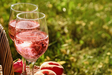 Canvas Print - Glasses of delicious rose wine outside, closeup. Space for text