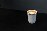 Fototapeta Mapy - latte coffee on a paper cup served on white table at cafe​