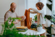 © Westend61 - Fashion designer with colleague folding clothes on table