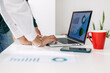 © Westend61 - Hands of businesswoman using laptop in front of colleague at desk