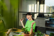 Happy Woman In Green T-shirt In Conference Room