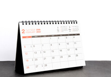 Month February 2023 Desk Calendar For Planners And Reminders On A Black Table On A White Background.
