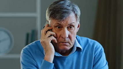 Close-up portrait male sad wrinkled face old caucasian man angry grandpa upset unhappy frustrated senior mature grandpa client talking phone conflict misunderstanding quarrel remote mental problems