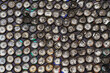 © ADDICTIVE STOCK - Abstract background of pile of metal bottle caps on wall