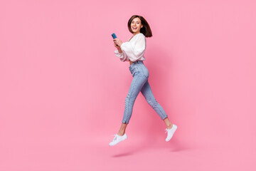 Wall Mural - Full length photo of positive blogger lady hold device gadget facebook instagram telegram step empty space isolated pink color background