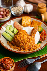 Wall Mural - Ayam Goreng Padang. Traditional fried chicken with spice crumbs from Minangkabau, West Sumatra. 