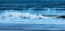 Blurred Motion Of Waves Crashing On The Shoreline; England, United Kingdom