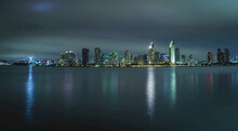San Diego Skyline Illuminated At Night With Reflections On The Bay; San Diego, California, United States Of America