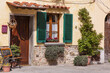 © Designpics - Traditional stucco home with wooden front door and window with green shutters on a sunny day in the town of Cortona; Arezzo, Tuscany, Italy