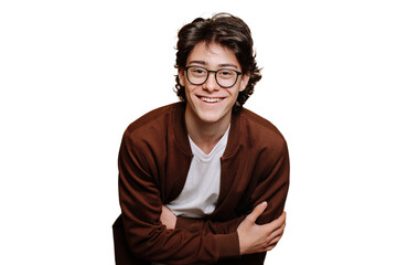 cheerful caucasian guy in glasses, brown sweatshirt and white t-shirt posing at studio against trans