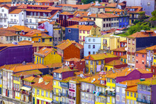 Traditional, Colorful Townhouses With Their Clay Tiled Rooftops Compacted Together In The Old City Center Along The Douro Riverside; Ribeira District, Porto, Norte Region, Portugal