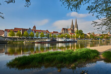 Outlook Over The Danube River With The Gothic St Peter's Cathedral From The Marc​-Aurel-shore In The Old Town Of Regensburg With A Blue Sky At Sunset; Regensburg, Bavaria, Germany