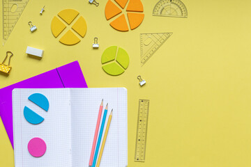 Wall Mural - School stationery, fractions, rulers, pencils on yellow background. Back to school, fun education concept. Set of supplies for mathematics and for school. Close up