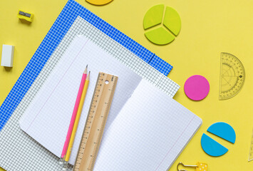 Wall Mural - School stationery, fractions, rulers, pencils on yellow background. Back to school, fun education concept. Set of supplies for mathematics and for school. Close up