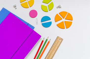 Wall Mural - School stationery, fractions, rulers, pencils on white background. Back to school, fun education concept. Set of supplies for mathematics and for school. Close up