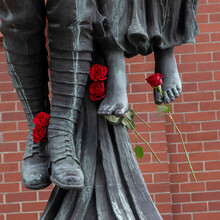 'Angel Of Victory' Bronze Sculpture, A Historic War Memorial With Fresh Red Roses Placed On The Feet Of The Sculpture; Vancouver, British Columbia, Canada