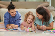 © DragonImages - Happy mothers and little daughter playing with toys and drawing pictures together at home