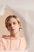 Gender Neutral Model With Glamorous Golden Earring Looking At Camera Portrait 