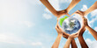 © Puttachat - Conceptual symbol of multiracial human hands surrounding the Earth globe. Unity, world peace, humanity concept. World environment day- Earth Day concept. Elements of this image furnished by NASA.