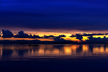 Poster - Minimalistic silhouette of a fishing boat on a calm lake after sunset.