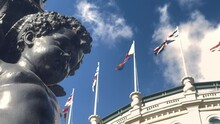 Antique Lamps And Statues On Trafalgar Square With Background View Of UK Flag 4k