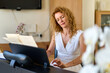 © JENOCHE - Woman in white dress sitting at the piano. Practice at home.