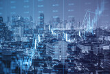 Fototapeta  - Glowing forex index chart/graph on toned dark city backdrop. Trade, finance and market concept Double exposure.