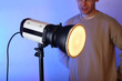 a flash with a modifier on with a diffuser with a person
