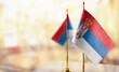 © butenkow - Small flags of the Serbia on an abstract blurry background
