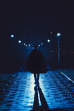 Fototapeta Londyn - mafia man in a hat and raincoat at night in a rainy city in the style of film noir