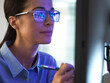 © Connect Images - Female expert in glasses looking at screen with financial data
