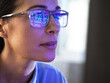 © Connect Images - Female expert in glasses looking at screen with financial data