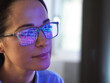 © Connect Images - Female expert in glasses looking at screen with financial data