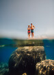 © Connect Images - USA, California, Boys standing on boulder in Lake Tahoe