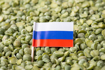 Poster - Close up shot of flag of russia on green pea. Concept of growing pea in russia