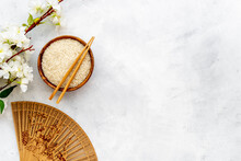 Chinese Or Japanese Background With Bowl Of Rice And Fan, Top View